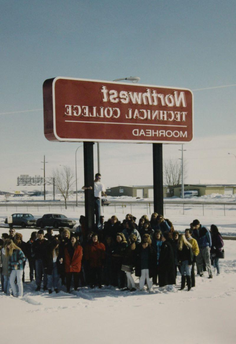 Students gather around the Moorhead college sign, in 1994